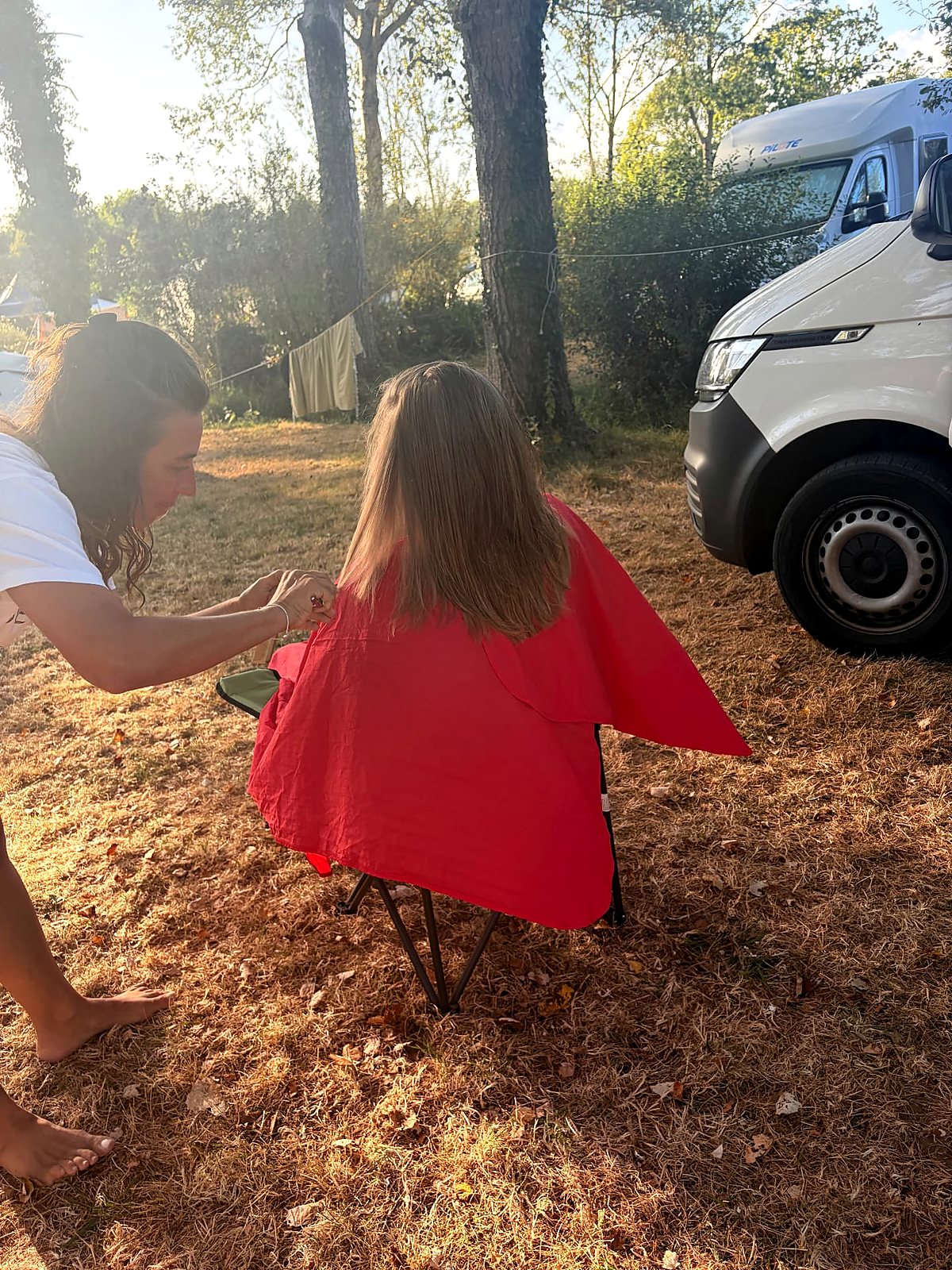 Annika cutting a client's hair outdoors