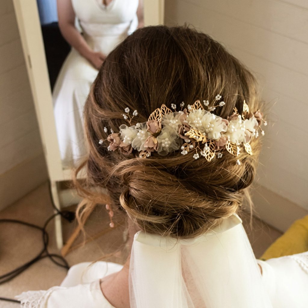 Updo with cream blossoms and golden details