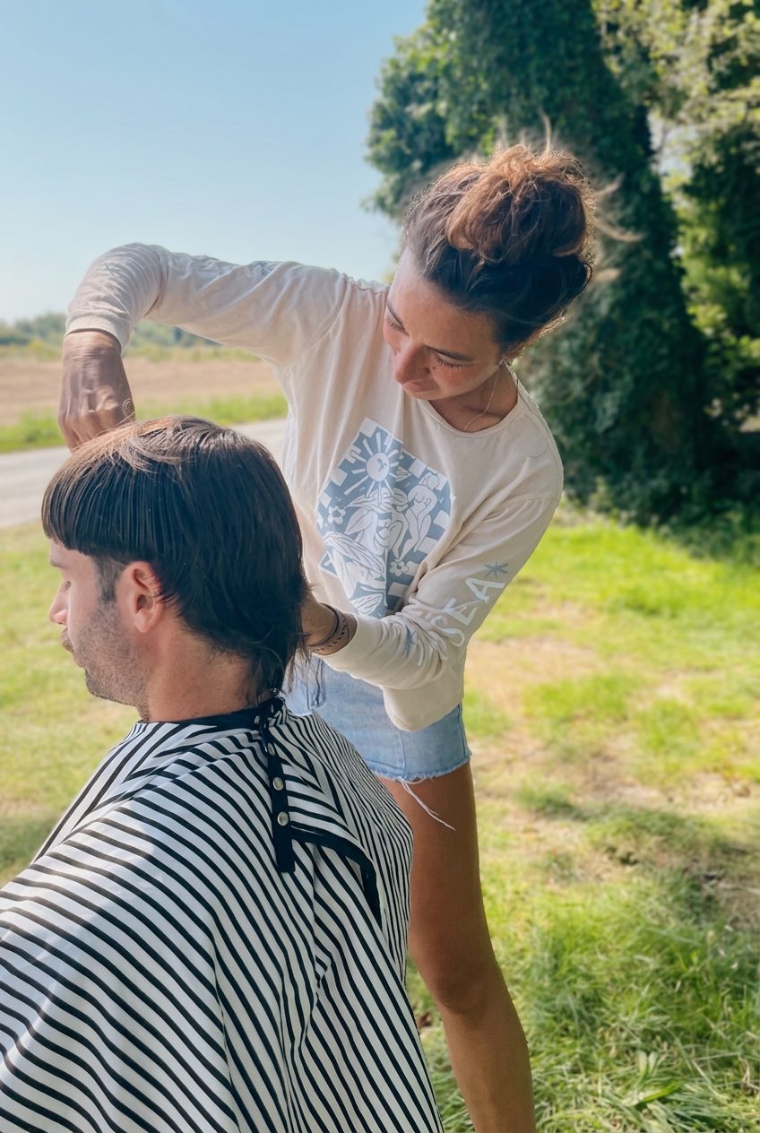 Haircut under the open sky, Annika cutting a men's haircut